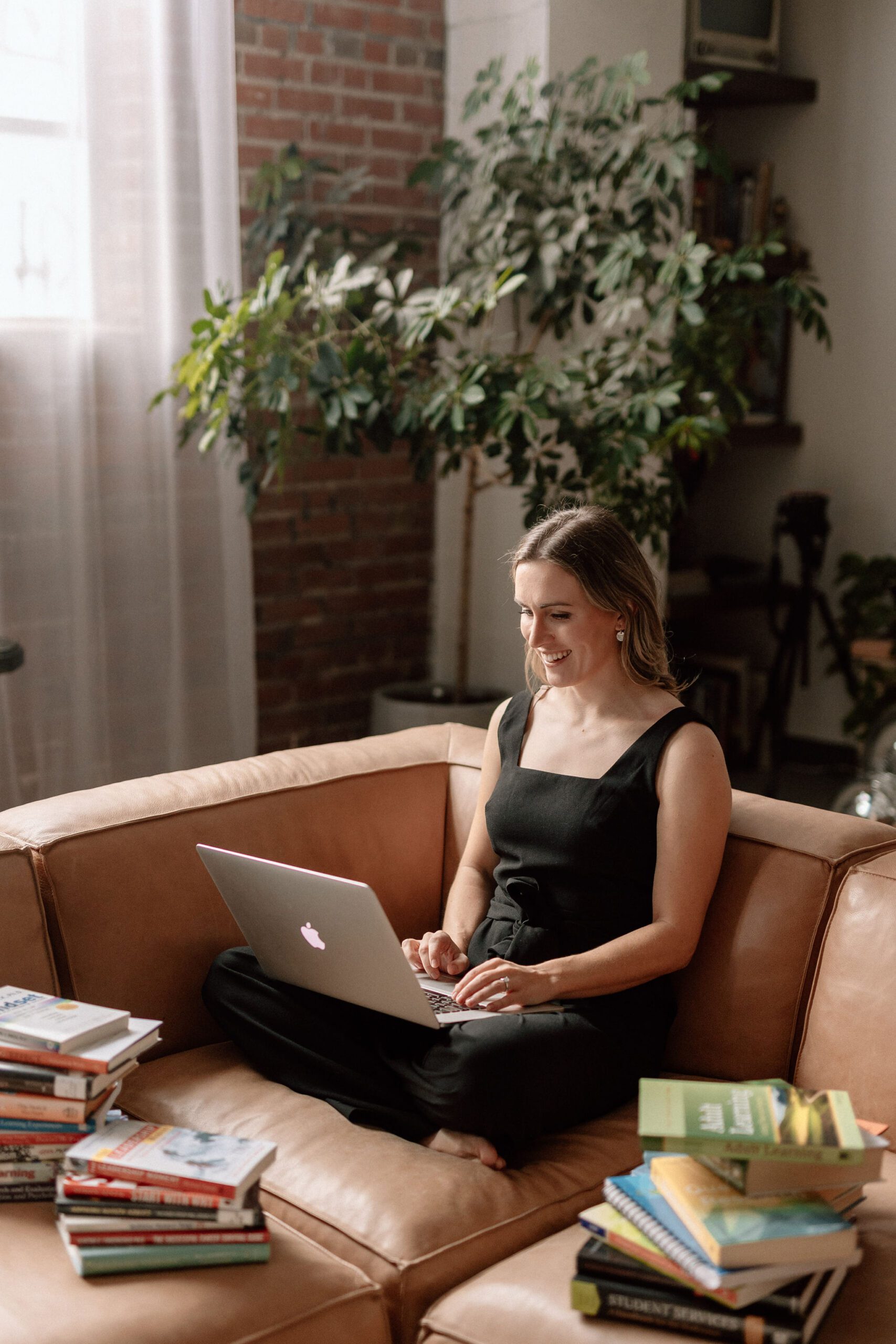 learning specialist lauren dewey sitting on a pleather couch