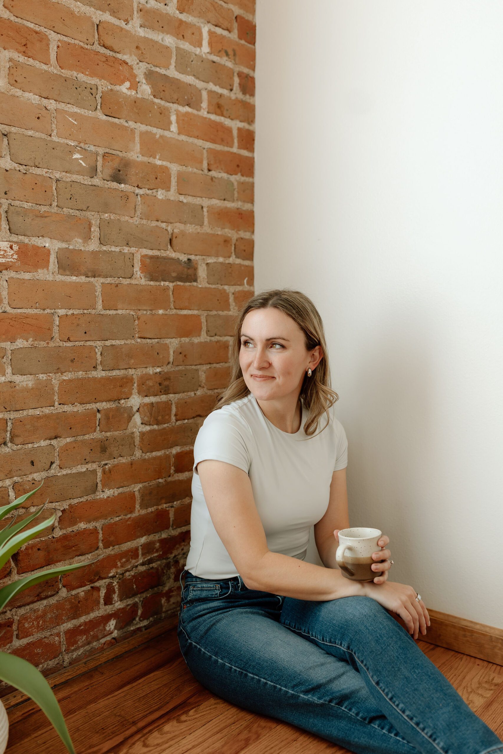 learning specialist sitting on floor drinking coffee